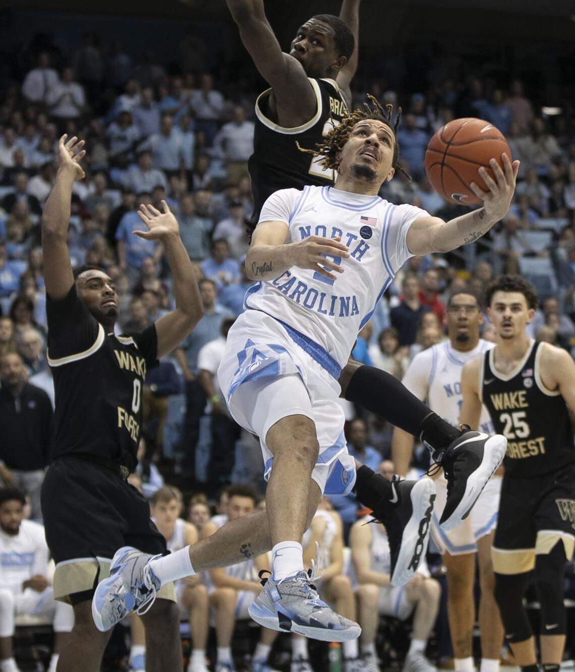 North Carolina’s Cole Anthony (2) drives to the basket past Wake Forest’s Jahcobi Neath (4) Chaundee Brown (23) during the second half on Tuesday, March 3, 2020 at the Smith Center in Chapel Hill, N.C.