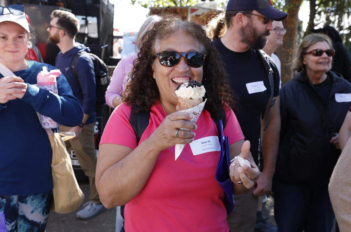 Kim Mueller enjoys a nutella oreo chimney cake from Magdalenas during the Foodie's Tour of the State Fair at the N.C. State Fair in Raleigh, N.C., Friday, October 17, 2025.