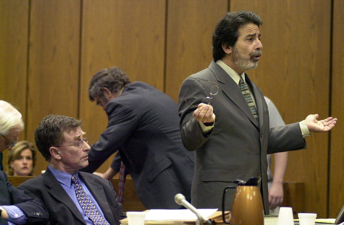 Defense attorney David Rudolf (right) argues a point during a hearing for Michael Peterson (left) in 2003.