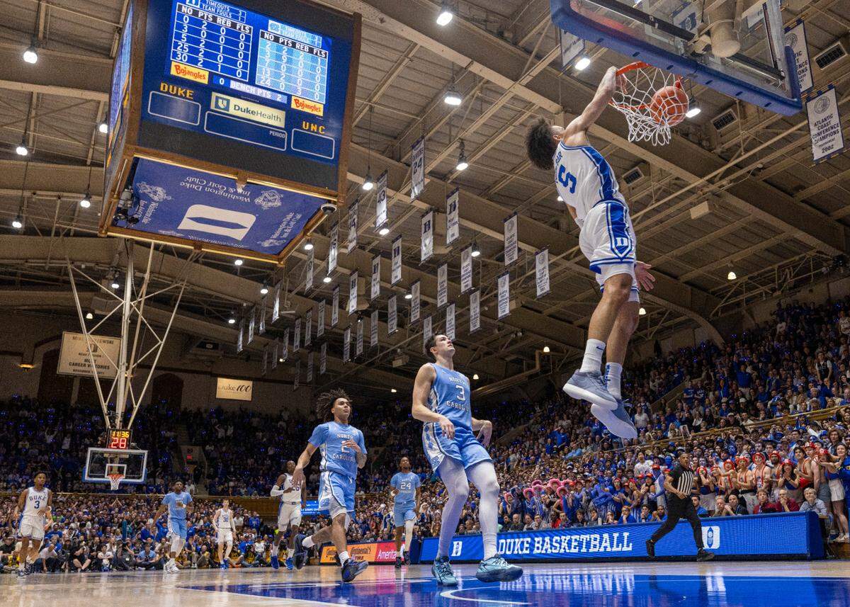 Duke’s Tyrese Proctor (5) scores on a fast break with a dunk ahead of North Carolina’s Cormac Ryan (3) during the first half on Saturday, March 9, 2024 at Cameron Indoor Stadium in Durham, N.C.