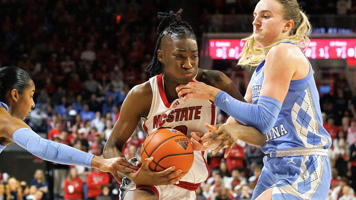 N.C. State’s Saniya Rivers splits the defense of North Carolina’s Deja Kelly and Alyssa Ustby during the second half of the Wolfpack’s 63-59 win on Thursday, Feb. 1, 2024, at Reynolds Coliseum in Raleigh, N.C.