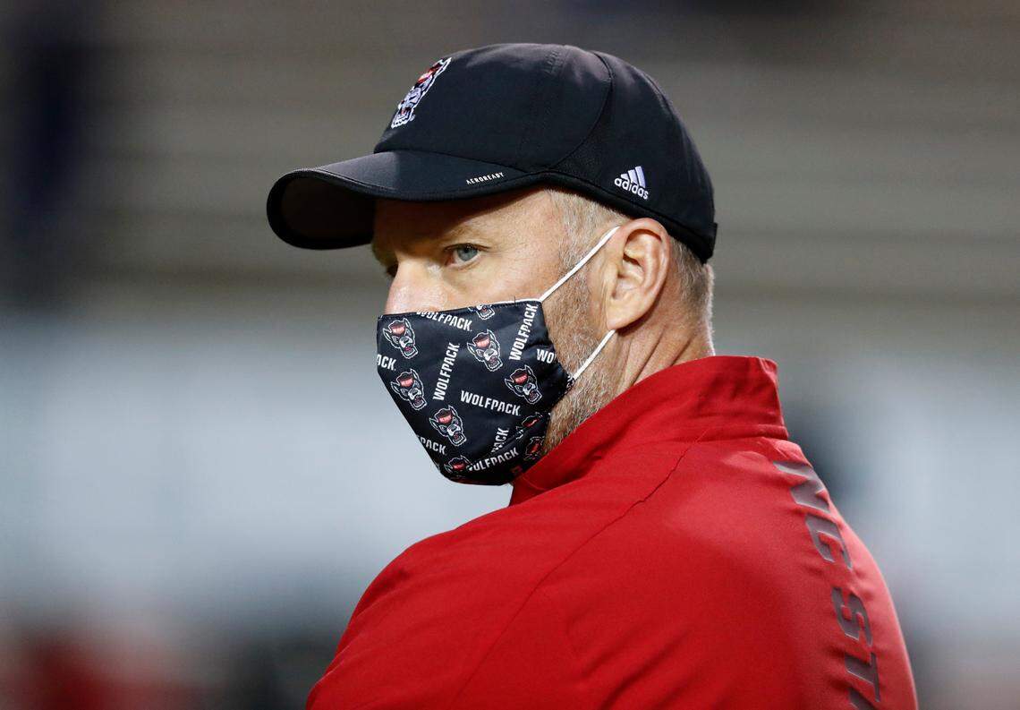 N.C. State head coach Dave Doeren watches his team warm up before N.C. State’s game against Wake Forest at Carter-Finley Stadium in Raleigh, N.C, Saturday, Sept. 19, 2020.