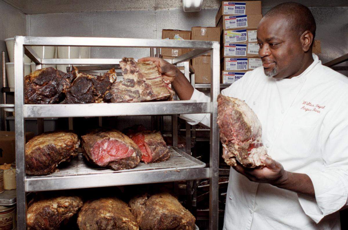 Walter Royal checks the aging beef before preparing it at the Angus Barn.