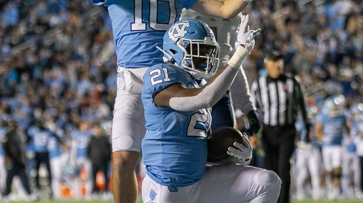 North Carolina’s Elijah Green (21) and quarterback Drake Maye react after a 1-yards run for a touchdown in the second quarter against Georgia Tech’s on Saturday, November 19, 2022 at Kenan Stadium in Chapel Hill, N.C.