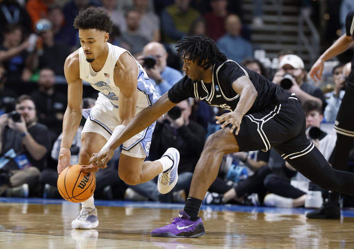 North Carolina's Seth Trimble (7) takes the ball from VCU’s Michael Belle (8) during the first half of UNC’s game against VCU in the first round of the NCAA Men’s Basketball Tournament at  Bon Secours Wellness Arena in Greenville, S.C., Thursday, March 19, 2026.