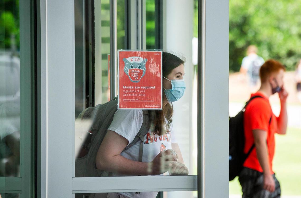 N.C. State students enter and exit the Talley Student Union where masks are required, on the first day of classes for the fall semester, on Monday, Aug. 16, 2021, in Raleigh, N.C.
