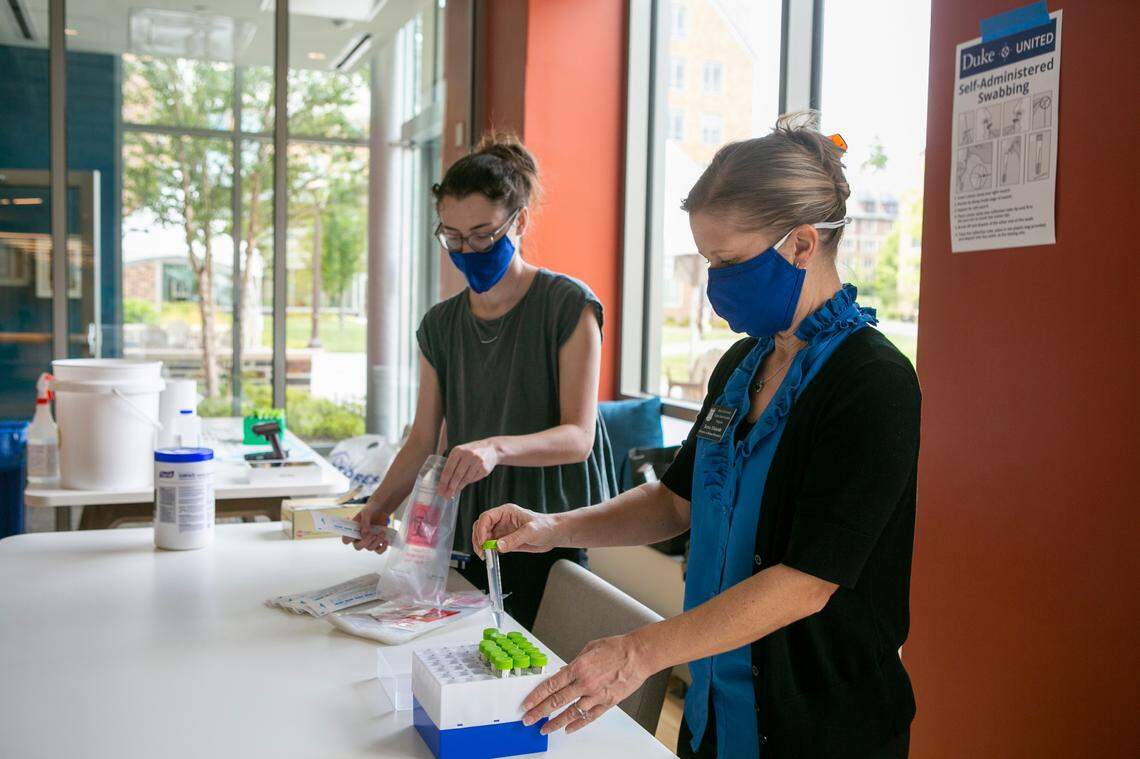 Duke University has launched COVID-19 surveillance testing on random students at multiple testing sites across East and West Campus, including here at The Hollows residence hall. Here, Jaclyn Komoski, left, and Terra Ylizarde set up supplies as they await students.