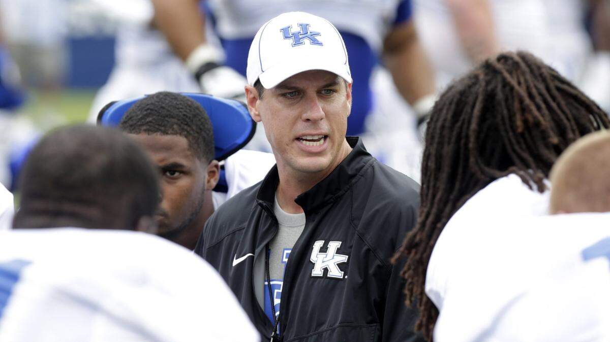 D.J. Eliot, Kentucky’s defensive coordinator, talks to players during an open practice at Commonwealth Stadium in Lexington, Ky. in 2014.
