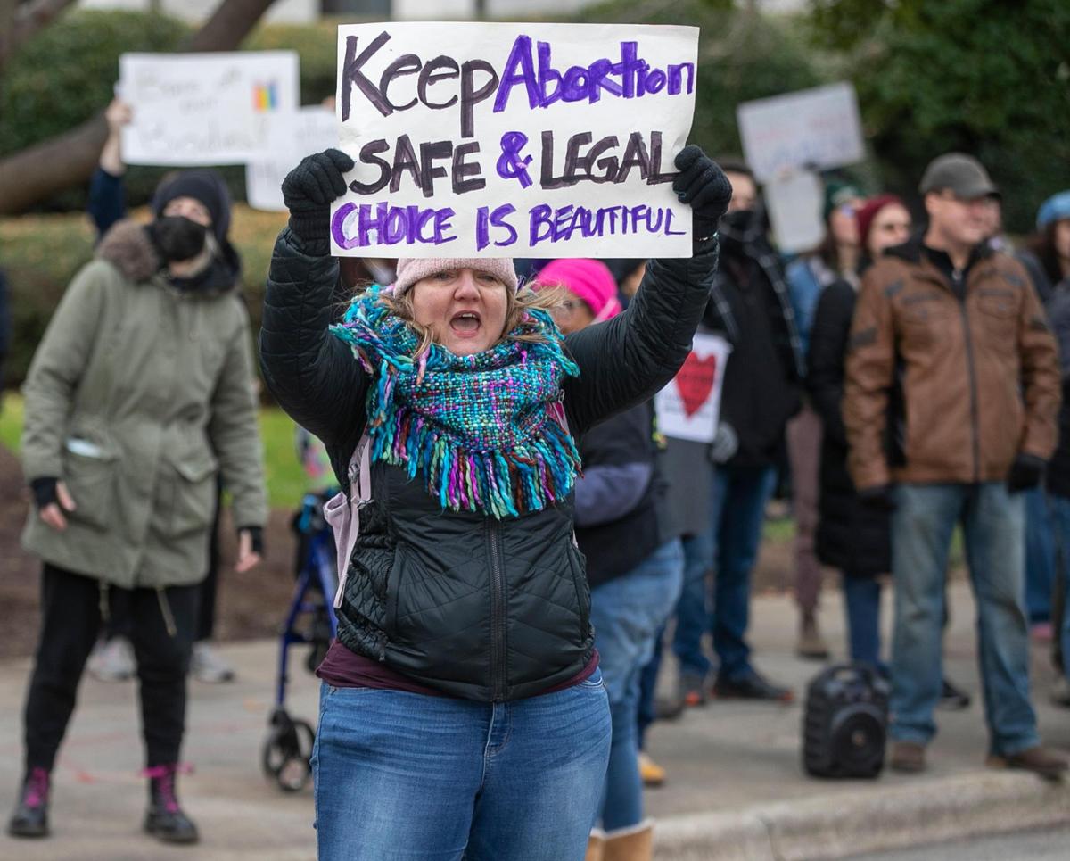 Pro-choice demonstrators counter as Right to Life advocates march past their group on the corner of N. Wilmington and Lane Streets on Saturday, January 14, 2023 in Raleigh, N.C.