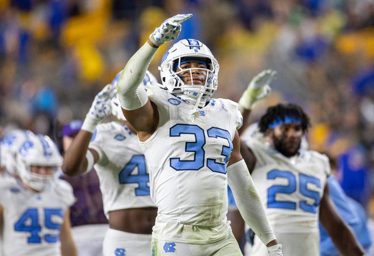 North Carolina’s Cedric Gray (33) and his teammates signal the start of the fourth quarter against Pitt on Saturday, September 23, 2023 at Acrisure Stadium in Pittsburgh, Pa.