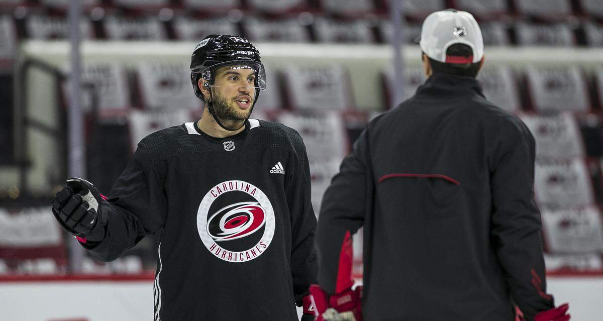 Carolina Hurricanes’s Tony DeAngelo (77) talks with coach Rod Brind’Amour during practice on Friday, May 13, 2022 as they prepare for game seven in the Stanley Cup first round series against Boston at PNC Arena in Raleigh, N.C.
