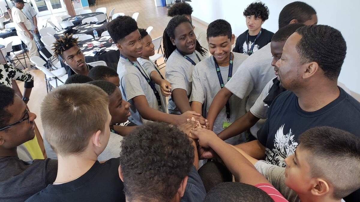 Sean Ingram with students at the Sean Ingram Academy. The school works with Wake County public high schools to help at-risk students. Ingram says 85 percent of the students who come to the academy graduate high school.