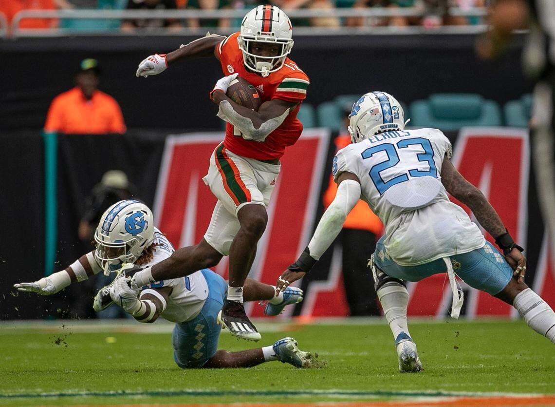 North Carolina’s Power Echols (23) and DeAndre Boykins (16) work to stop Miami’s Brashard Smith (12) on Saturday, October 8, 2022 at Hard Rock Stadium in Miami Gardens, Florida.