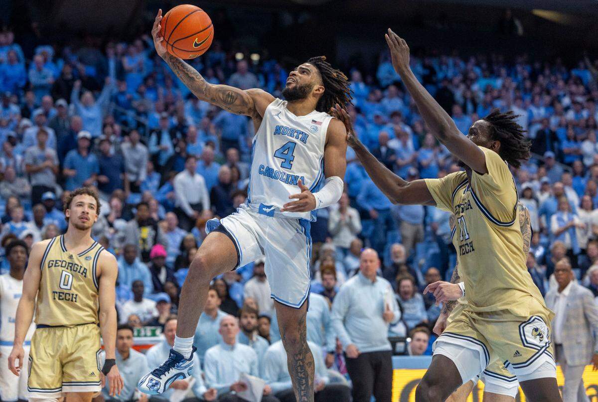 North Carolina guard R.J. Davis breaks to the baskets against Georgia Tech’s Baye Nidongo (11), to give the Tar Heels a four point lead in the second half on Saturday, December 7, 2024 at the Smith Center in Chapel Hill, N.C. Davis scored 16 points in the Tar Heels’ 68-65 victory.