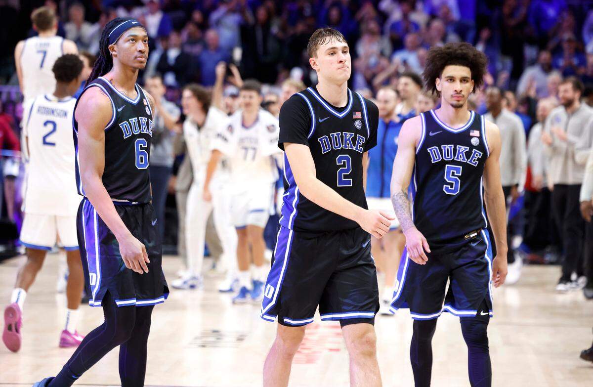 Duke’s Maliq Brown (6), Cooper Flagg (2) and Tyrese Proctor (5) walk off the court after Kentucky’s 77-72 victory over Duke in the State Farm Champions Classic in Atlanta, Ga., Tuesday, Nov. 12, 2024.