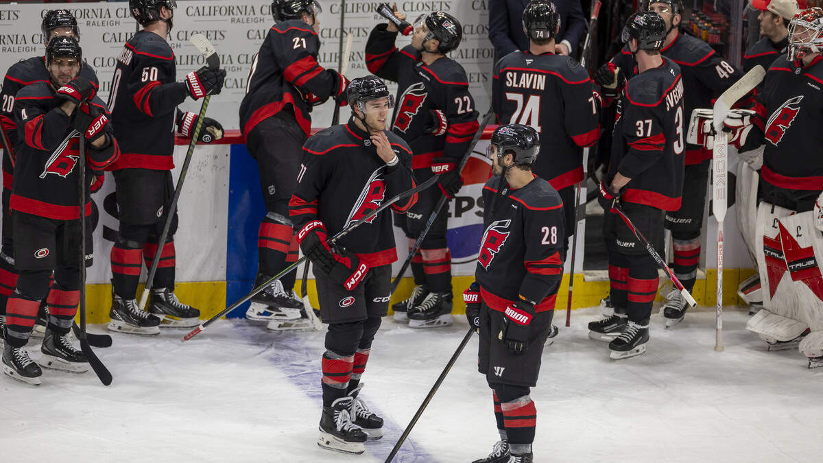 Carolina Hurricanes left wing Mark Jankowski (77) talks with William Carrier (28), as they wait for a review of Jankowski’s goal in the first overtime period of Game 2 against Ottawa on Monday, April 20, 2026 during the first round of the Stanley Cup Playoffs at Lenovo Center in Raleigh, N.C. 