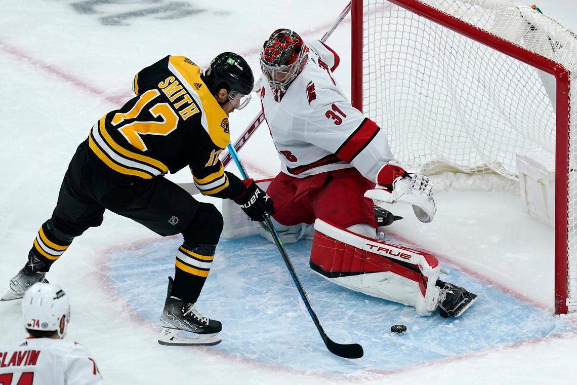 Carolina Hurricanes goaltender Frederik Andersen (31) makes a save against a shot by Boston Bruins center Craig Smith (12) during the first period of an NHL hockey game, Thursday, Feb. 10, 2022. (AP Photo/Charles Krupa)