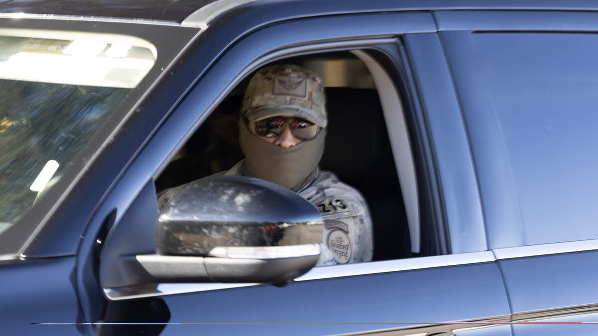 A Border Patrol agent searches a neighborhood in Southeast Raleigh, Nov. 18, 2025.
