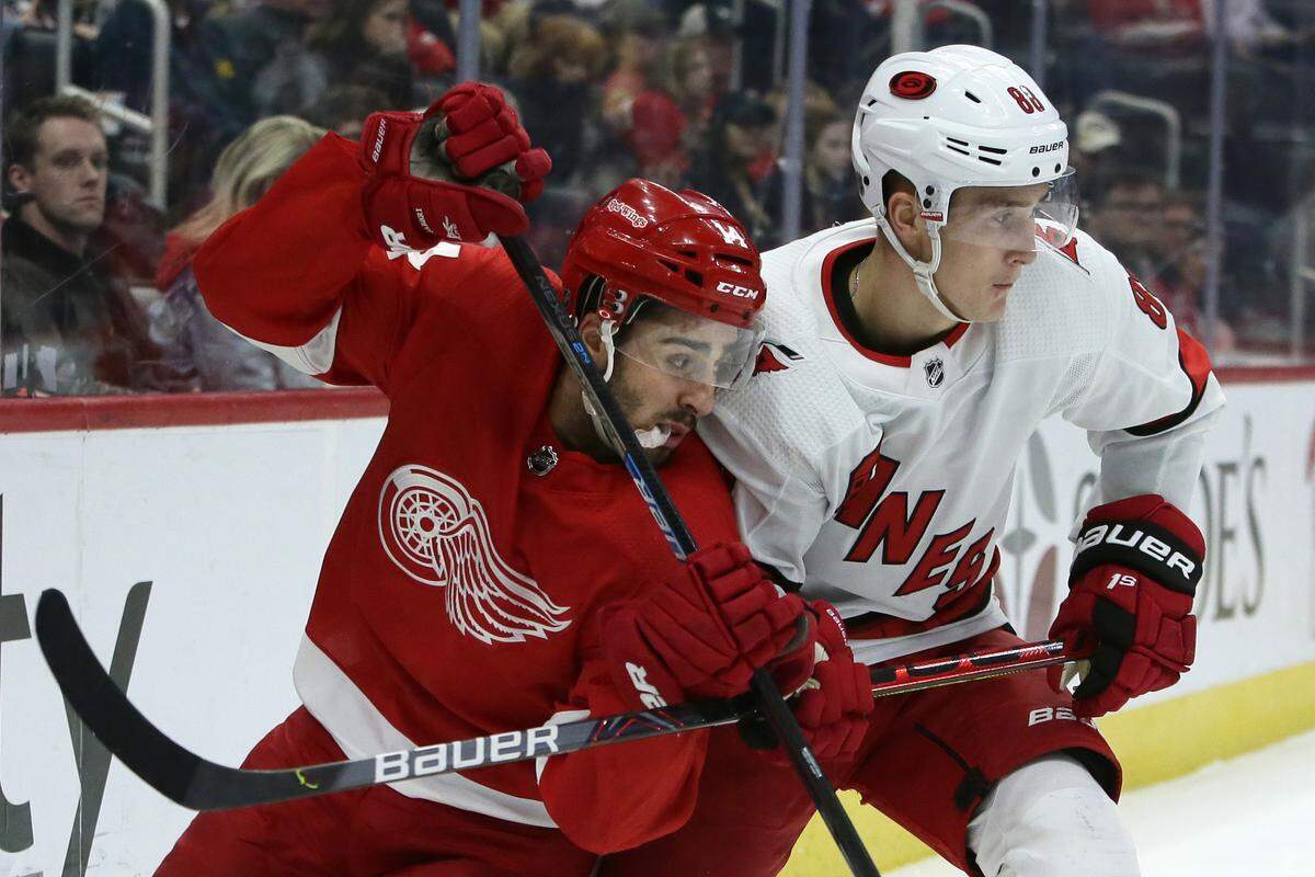 Carolina Hurricanes center Martin Necas (88) holds off Detroit Red Wings center Robby Fabbri (14) during the third period of an NHL hockey game Tuesday, March 10, 2020, in Detroit. The Hurricanes defeated the Red Wings 5-2. (AP Photo/Duane Burleson)
