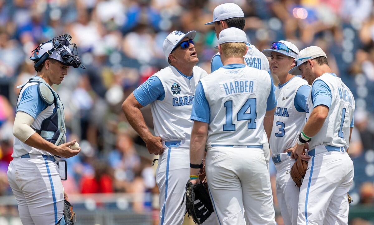 North Carolina coach Scott Forbes has a word with starting pitcher Aidan Haugh (47) before removing him from the game in the third inning against Florida State during game nine of the College World Series on Tuesday, June 18, 2024 at Charles Schwab Field in Omaha, Nebraska.