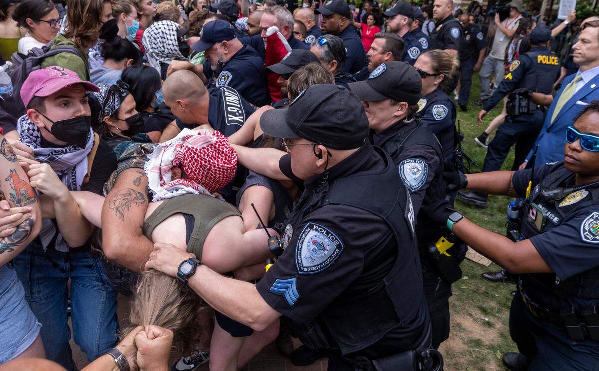 Pro-Palestinian demonstrators clash with police on April 30, 2024 after replacing an American flag with a Palestinian flag at the University of North Carolina-Chapel Hill campus in Chapel Hill, N.C.