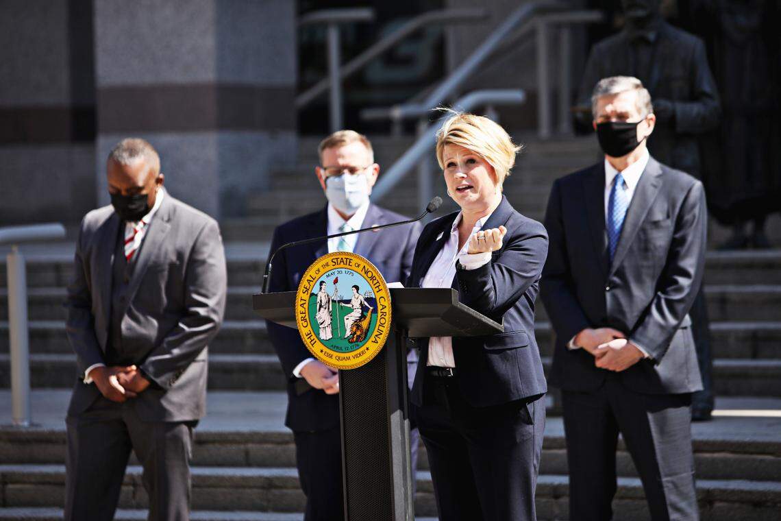 North Carolina superintendent Catherine Truitt, third from left, and lawmakers gather Wednesday morning, March 10, 2021, to announce that leaders of the Republican-led state legislature and the governor have reached an agreement to reopen the state’s K-12 public schools to full-time daily instruction.