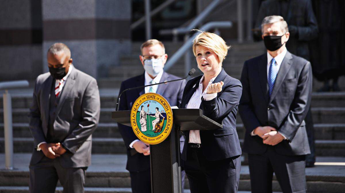 North Carolina superintendent Catherine Truitt, third from left, and lawmakers gather Wednesday morning, March 10, 2021, to announce that leaders of the Republican-led state legislature and the governor have reached an agreement to reopen the state’s K-12 public schools to full-time daily instruction.