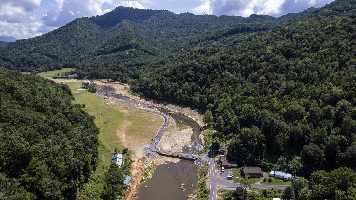 An aerial view of the ongoing repairs and newly completed road and bridge work along U.S. 19W along the Cane River in Yancey County on Aug. 14. Flooding from the remnants of Hurricane Helene washed away large sections of the highway in September 2024.