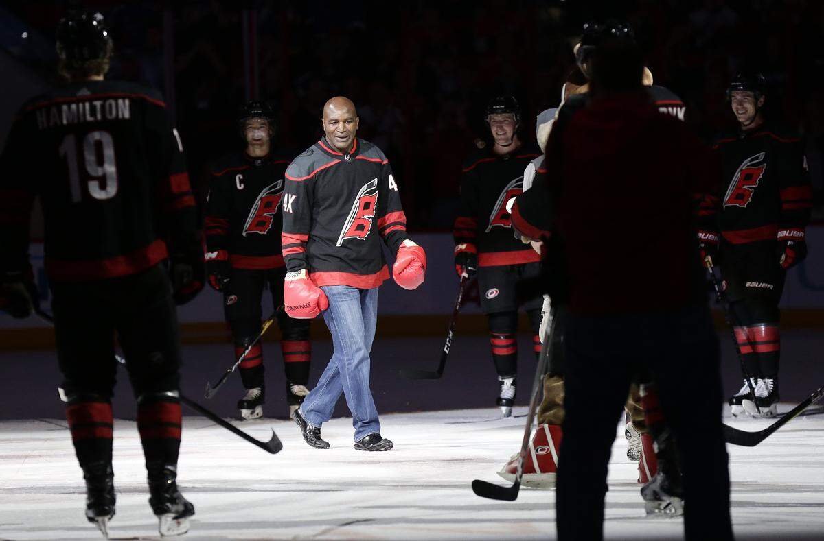 Former professional boxer Evander Holyfield joins the Carolina Hurricanes’ on-ice celebration after the Hurricanes defeated the St. Louis Blues 5-2 on Friday.