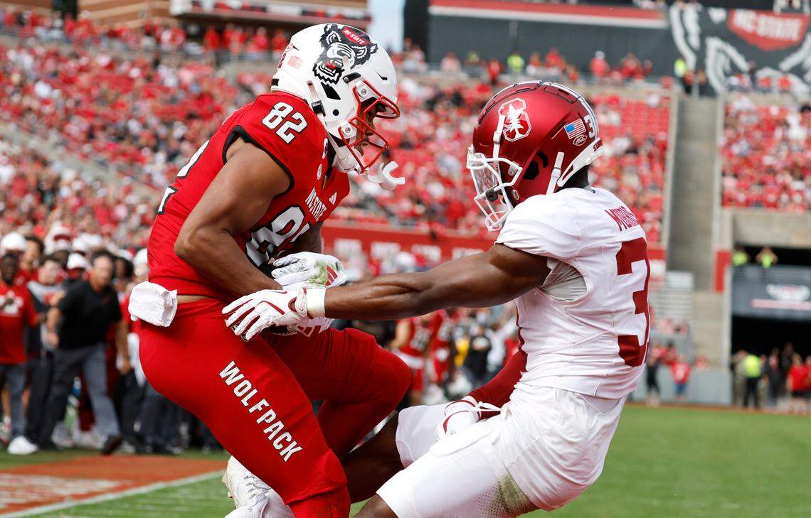 N.C. State wide receiver Keenan Jackson (82) pulls in a eight-yard touchdown reception as Stanford cornerback Aaron Morris (31) defends during the first half of N.C. State’s game against Stanford at Carter-Finley Stadium in Raleigh, N.C., Saturday, Nov. 2, 2024.
