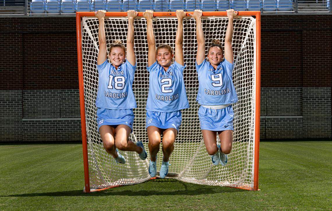 From left North Carolina lacrosse sisters Ashley Humphrey (18), Chloe Humphrey (2) and Nicole Humphrey (9) pose at Dorrance Field on the campus of UNC Friday, May 2, 2025.