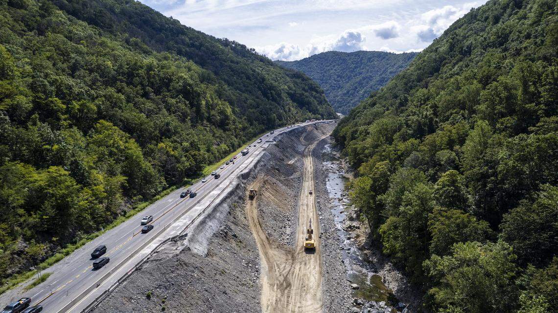 Contractors have built a causeway along the Pigeon River from which they will rebuild the eastbound lanes of Interstate 40 through the Pigeon River Gorge. Photo taken Aug. 28, 2025.