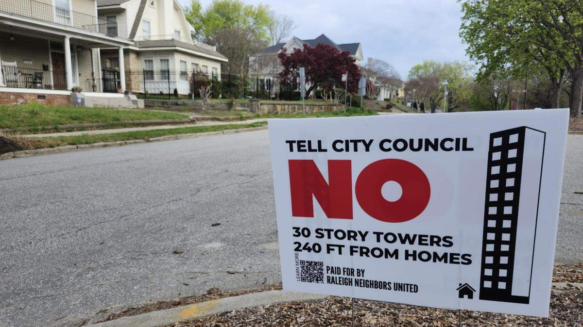 Signs dot streets near the Glenwood-Brooklyn Historic Neighborhood against a proposed rezoning at the intersection of Peace and West streets.