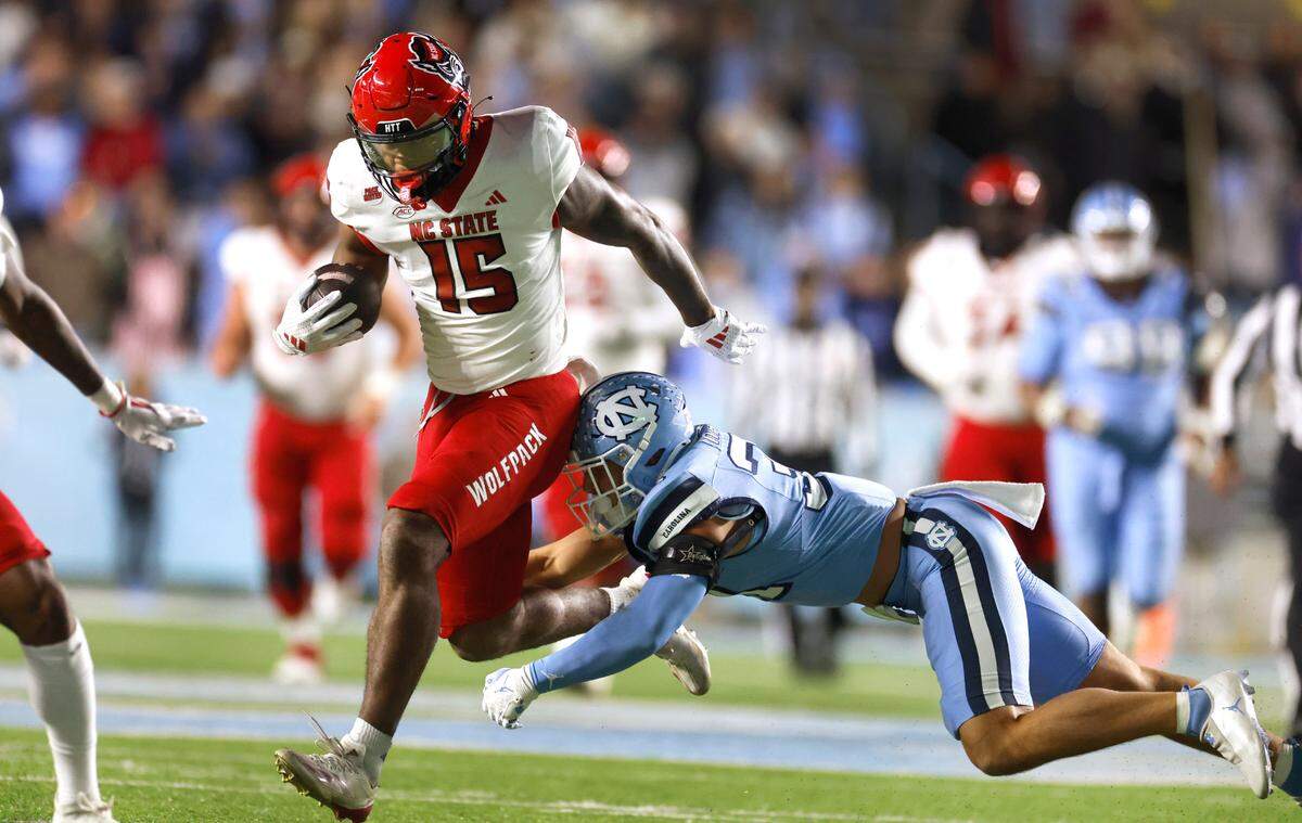 N.C. State tight end Justin Joly (15) escapes North Carolina defensive back Will Hardy (31) after making a reception during the second half of N.C. State’s 35-30 victory over UNC at Kenan Stadium in Chapel Hill, N.C., Saturday, Nov. 30, 2024.