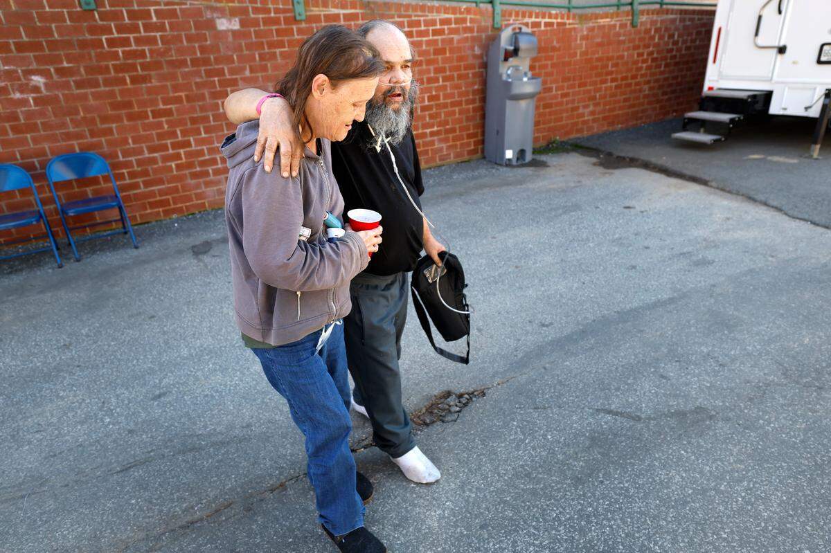 Joyce Lyons helps her husband David head back to the Red Cross shelter in Newland, N.C., on Thursday, Oct. 10, 2024. The couple’s mobile home on the Elk River, which they lived in since 1992, was engulfed by flood waters and floated away after Hurricane Helene passed the area. They are living in the shelter until they can find temporary housing.