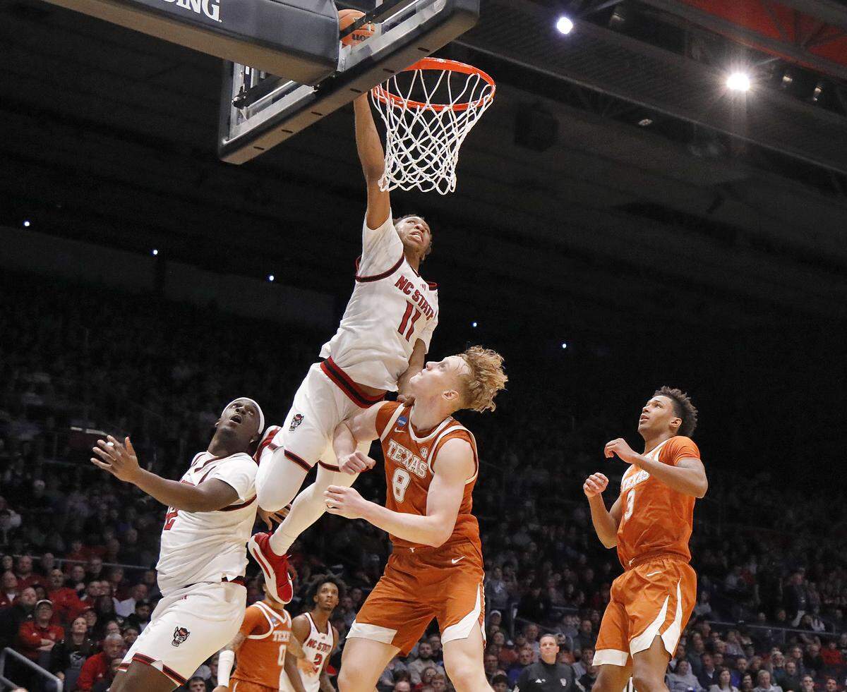 N.C. State’s Quadir Copeland drives to the basket past Texas’ Matas Vokietaitis during the second half of the Wolfpack’s 68-66 loss in the NCAA First Four on Tuesday, March 17, 2026, at the  in Dayton, Ohio. 