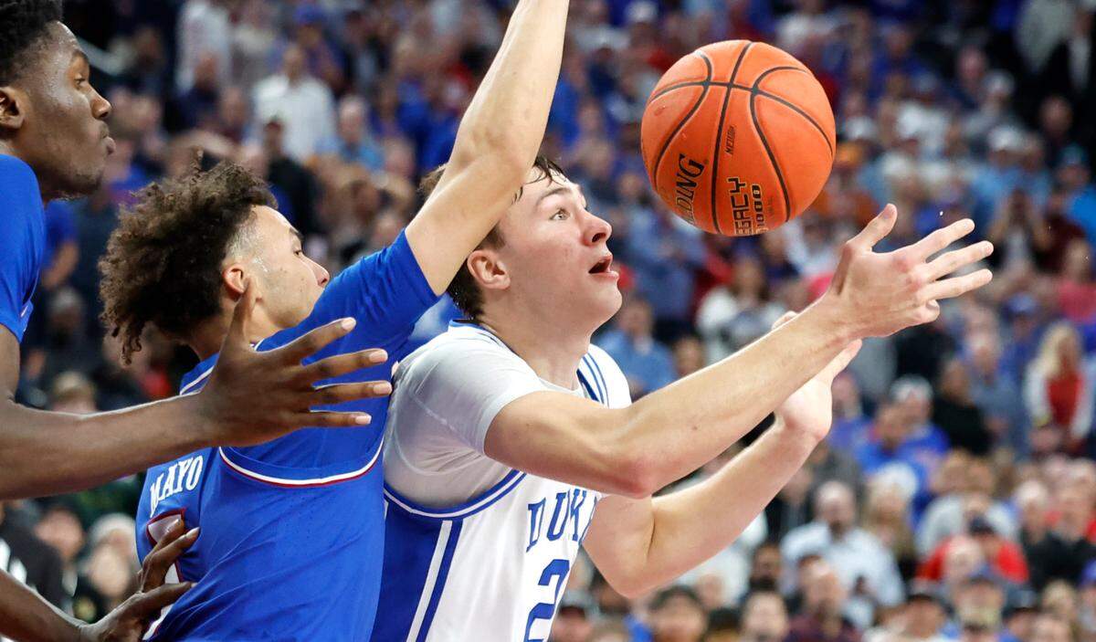 Duke’s Cooper Flagg (2) turns the ball over defended by Kansas’ Zeke Mayo (5) with 48 seconds left in the game during Kansas’ 75-72 victory over Duke in the Vegas Showdown at T-Mobile Arena in Las Vegas, Nev., Tuesday, Nov. 26, 2024.
