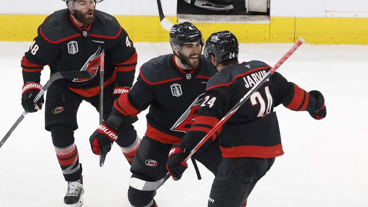 Carolina's Shayne Gostisbehere (4) celebrates with Seth Jarvis (24) after he scored in overtime of the Hurricanes’ 4-3 victory over the Golden Knights in the second game of the Stanley Cup Final at the Lenovo Center in Raleigh, N.C., Thursday, June 4, 2026.