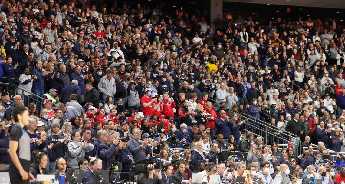 N.C. State fans are surrounded by Connecticut fans during the first half of the Wolfpacks game against the Huskies in the Bridgeport Regional final at Total Mortgage Arena in Bridgeport, Conn., Monday, March 28, 2022.