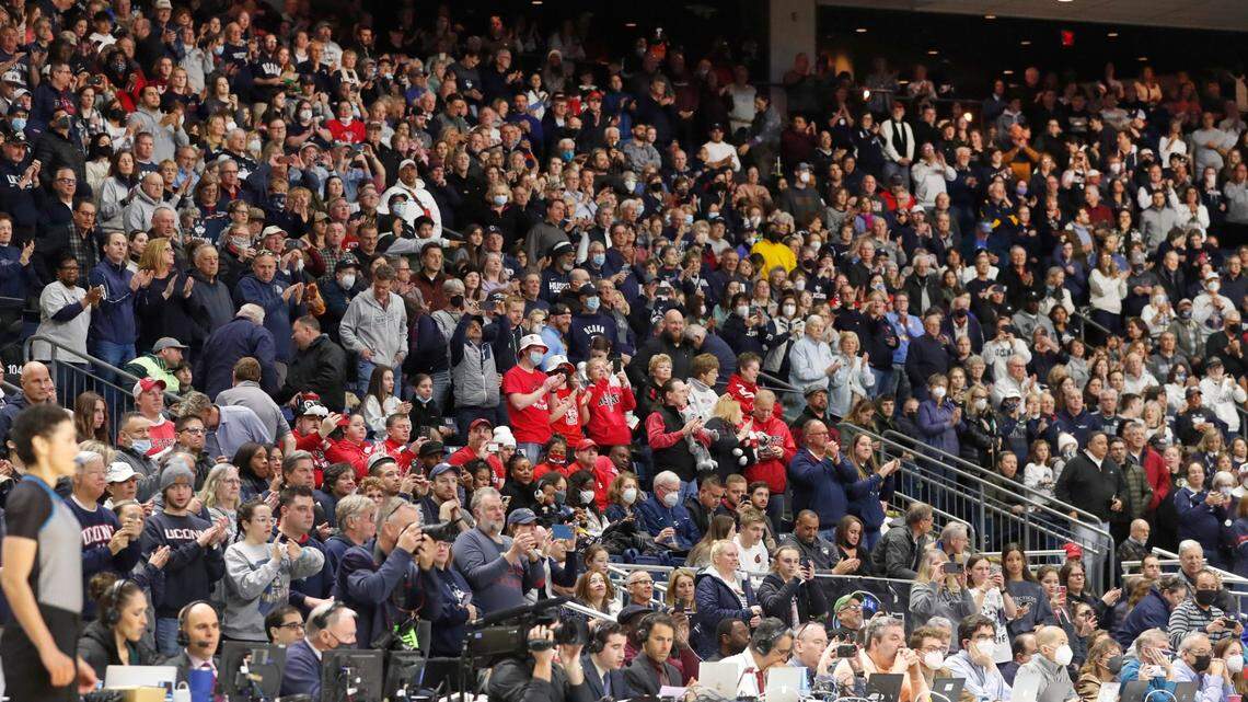 N.C. State fans are surrounded by Connecticut fans during the first half of the Wolfpacks game against the Huskies in the Bridgeport Regional final at Total Mortgage Arena in Bridgeport, Conn., Monday, March 28, 2022.