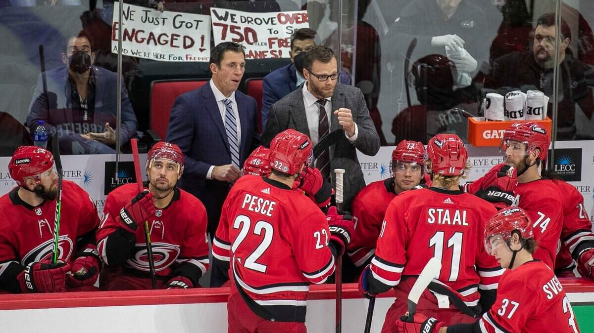 Carolina Hurricanes coach Rod Brind’Amour, in the suit on the left, said Wednesday that the NHL’s postponement of the Canes-Flyers game was “botched all the way around.”