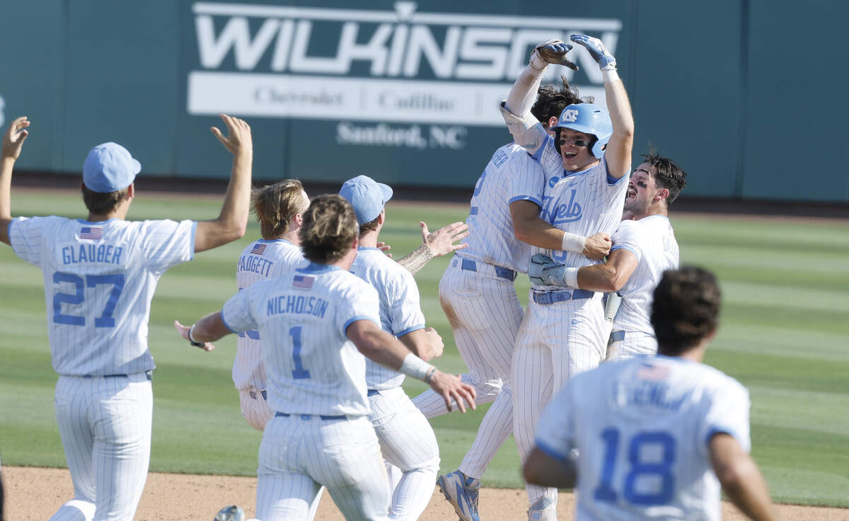 North Carolina's Owen Hull (8) is mobbed by teammates after making the winning hit in UNC’s 4-3 victory over USC at Boshamer Stadium to win the Chapel Hill Super Regional on Sunday, June 7, 2026.