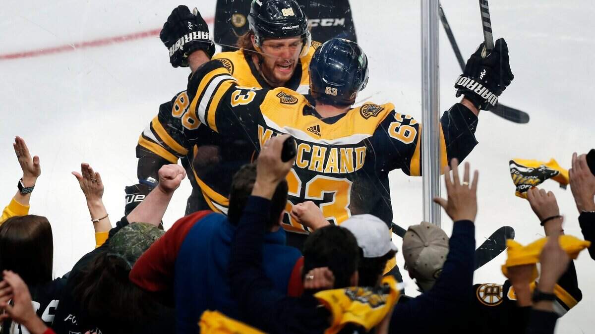 Boston Bruins’ Brad Marchand (63) celebrates his goal with David Pastrnak during the second period of Game 3 of an NHL hockey Stanley Cup first-round playoff series against the Carolina Hurricanes, Friday, May 6, 2022, in Boston. (AP Photo/Michael Dwyer)