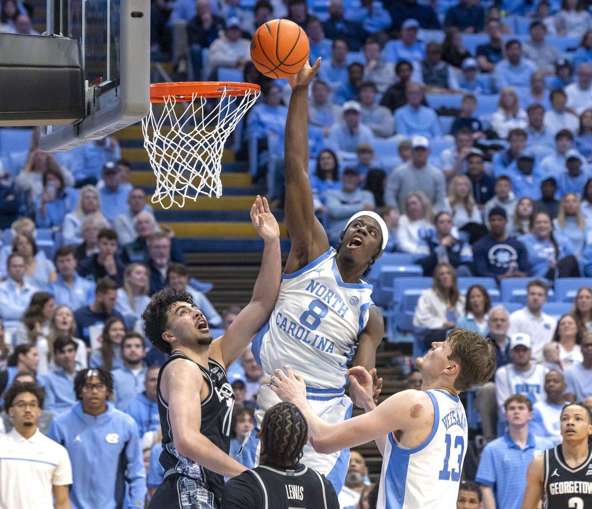 North Carolina forward Caleb Wilson (8) puts up a shot against Georgetown center Julius Halaifonua (11) in the second half on Sunday, December 7, 2025 at the Smith Center in Chapel Hill, N.C.  Wilson lead the Tar Heels with 20 points in their 81-61 victory.