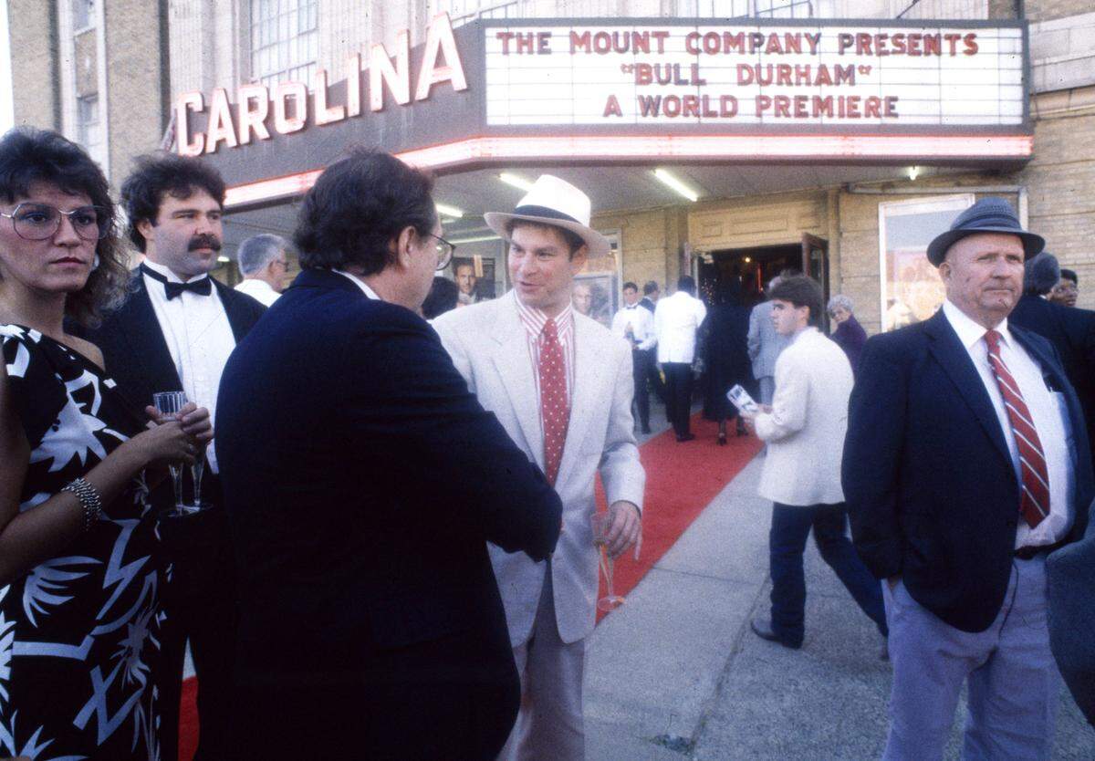 “Bull Durham” cast member Robert Wuhl, center, attends the premiere at the Carolina Theatre in Durham.