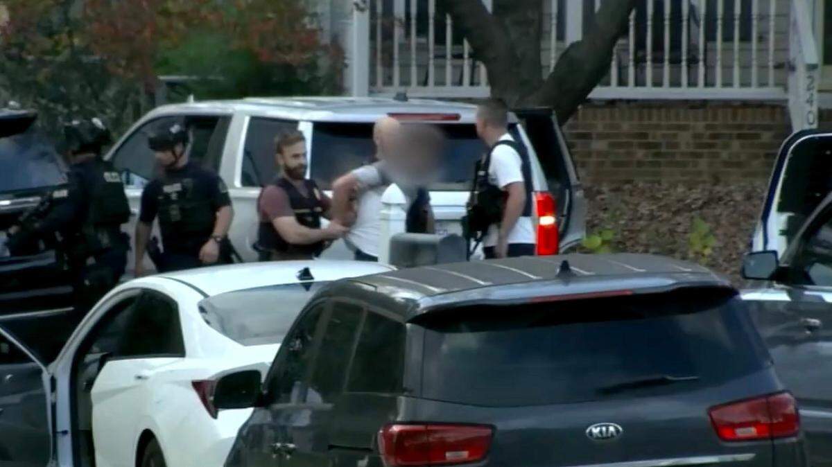 A screen capture from ABC11 shows one of two men being taken into custody by law enforcement officers at a residence on Denny Drive in Raleigh in connection with shots fired into vehicles in the area in the past several days.