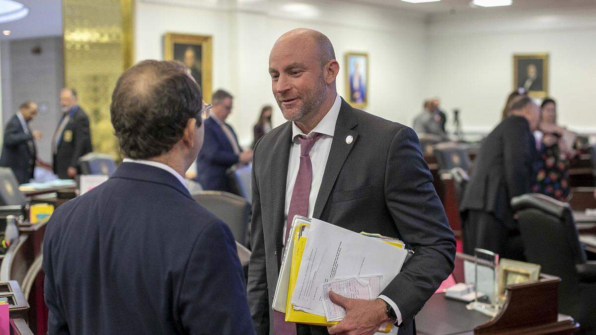 Sen. Danny Britt talks with Sen. Michael Lazzara following a vote on the state budget on Wednesday, November 17, 2021 in Raleigh, N.C.
