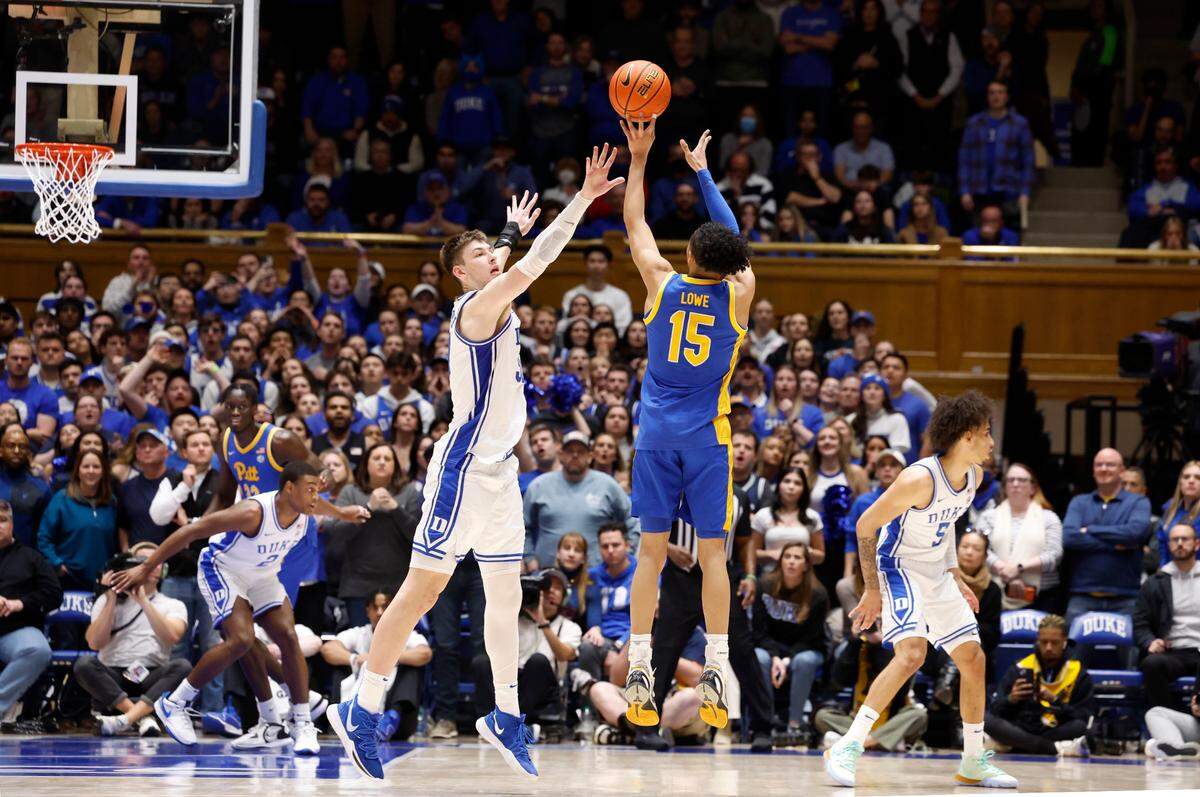 Pittsburgh’s Jaland Lowe (15) hits a three-pointer as Duke’s Kyle Filipowski (30) defends with :43 seconds left in the game to put Pitt up 75-71 during Pitt’s 80-76 victory over Duke at Cameron Indoor Stadium in Durham, N.C., Saturday, Jan. 20, 2024.