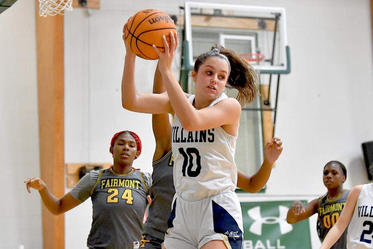 Bishop McGuinness guard Adelaide Jernigan (10) secures the rebound against Fairmont’s Shamiah Smith (10) during the second half. The Bishop McGuinness Villains and the Fairmont Golden Tornadoes met in the John Wall Holiday Invitational Tournament in Raleigh, N.C. on December 27, 2024.