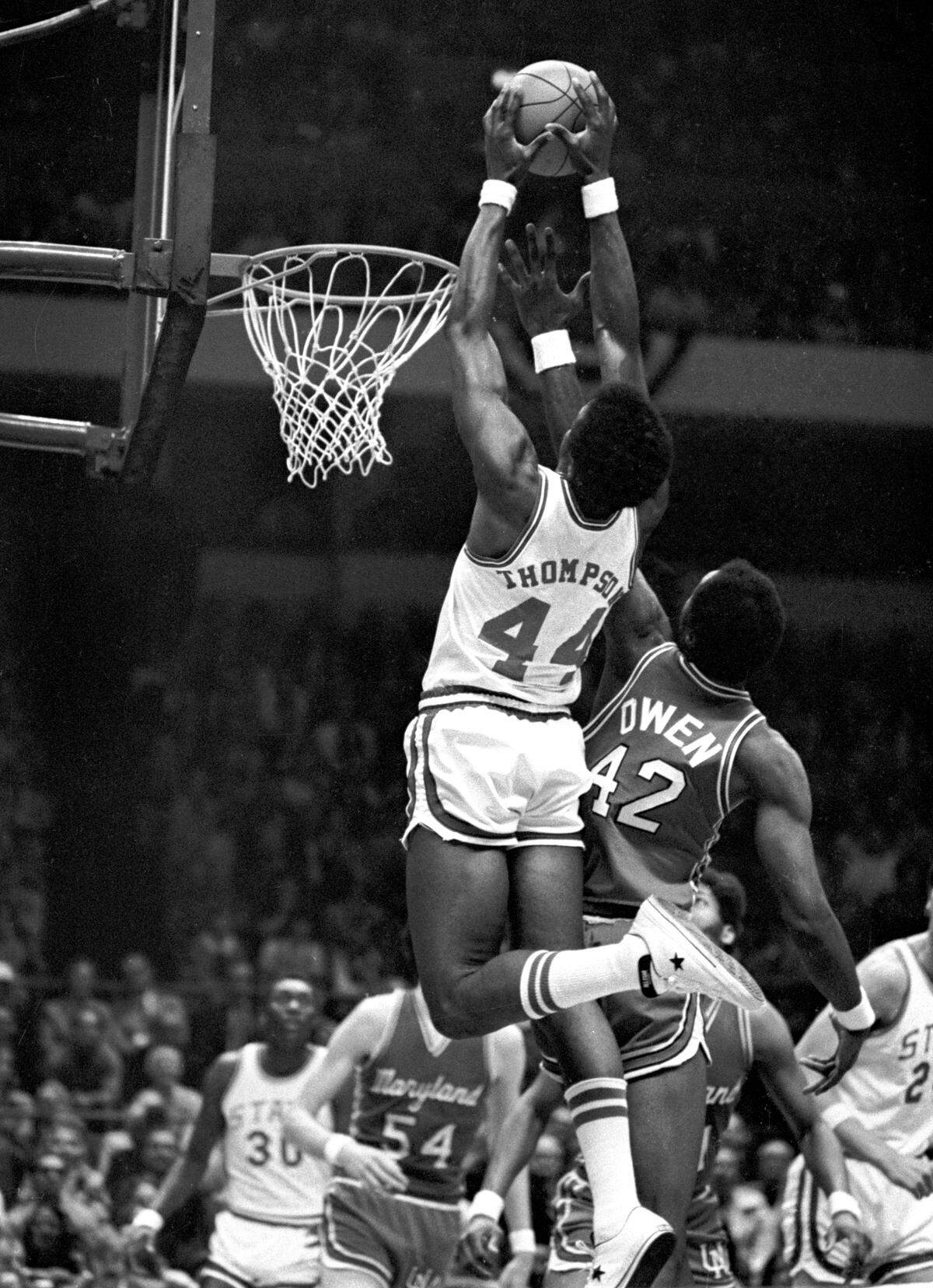 NC State’s David Thompson soars above the rim against Maryland in the 1974 ACC Tournament championship game. Since dunking wasn't allowed in Thompson's collegiate career, he perfected dropping the ball in on the business end of alley oop passes.